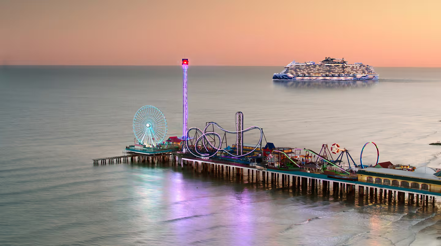 Cruise ship sailing near Galveston Island Historic Pleasure Pier at sunset