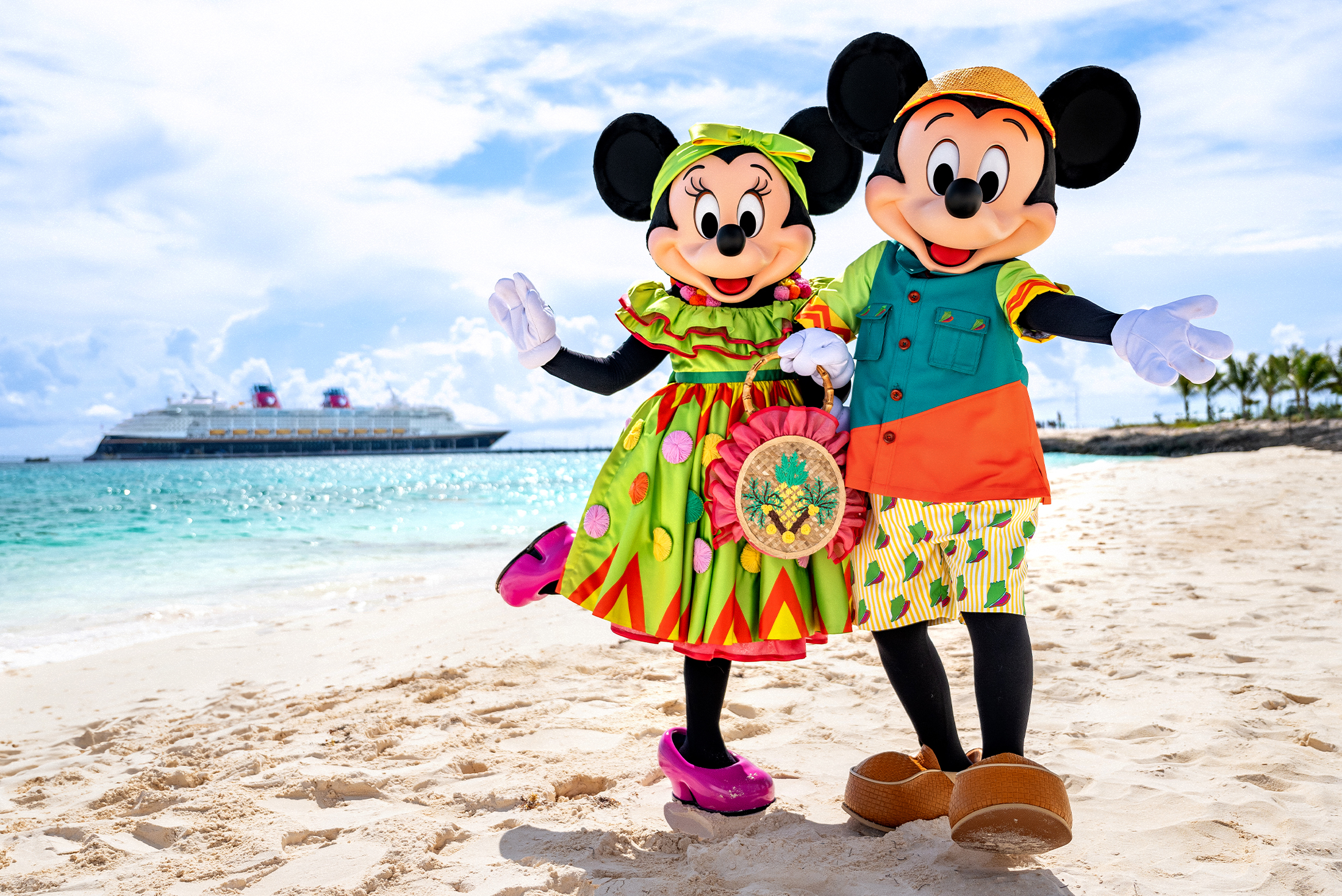 Mickey Mouse and Minnie Mouse on a beach with a Disney cruise ship in the background