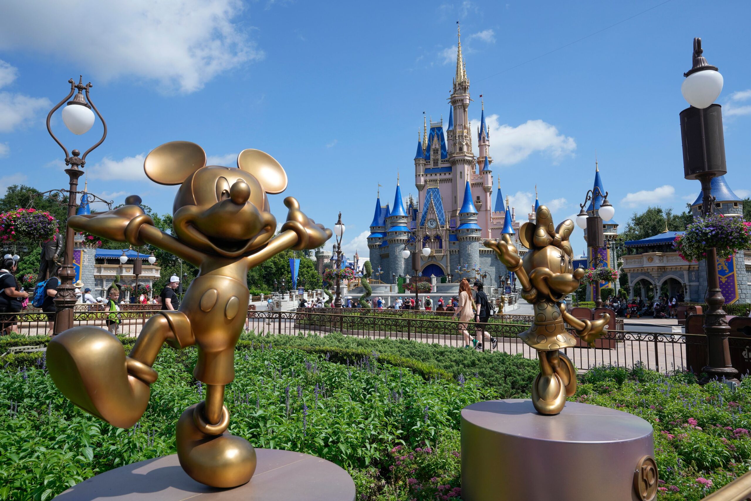 Mickey Mouse and Minnie Mouse statues with Cinderella Castle at Walt Disney World